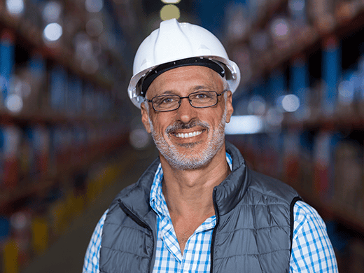 a man wearing a hard hat and vest working in a pest control industry